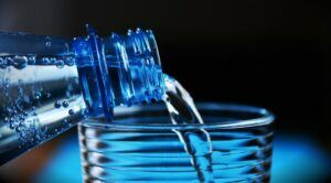 water in water bottle is pouring into a glass