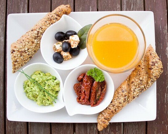 plate consiting of healthy breakfast including blueberries and orange juice