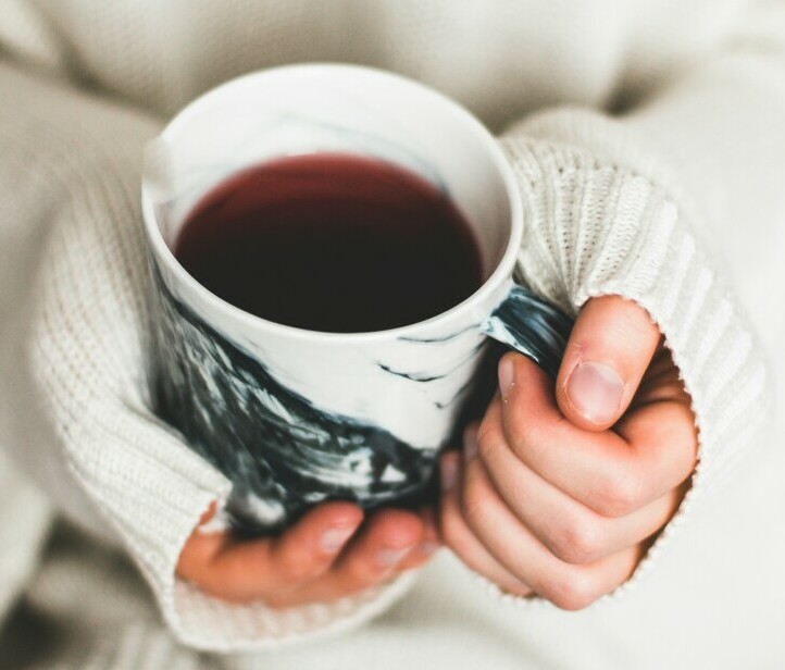 person holding a cup of tea