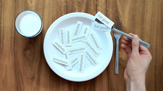 person holding up the words eat good, feel good when curbing hunger while fasting